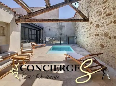 a villa with a swimming pool in front of a building at Hidden Oasis - Maison de caractère avec piscine in Azille
