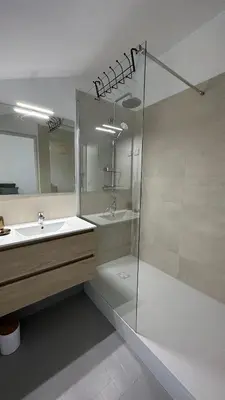 a bathroom with a shower and a sink and a mirror at Chambre Ginkgo au Domaine de l'Aven in Villeneuve-Minervois