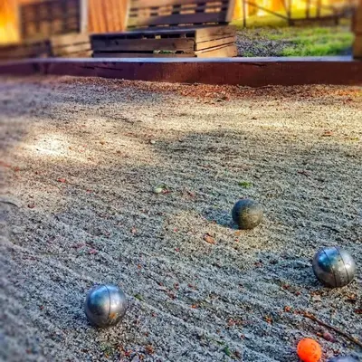 three balls sitting on the ground in front of a building at L'Entre Nous à Carcassonne in Carcassonne