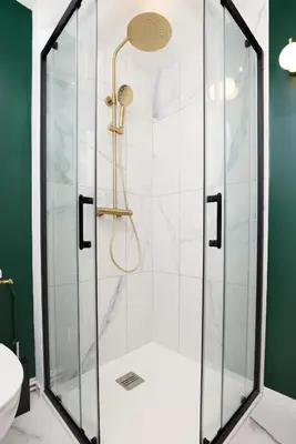 a bathroom with a shower with a glass door at Le T2 Chic ! in Carcassonne
