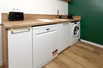 a kitchen with a sink and a washing machine at Le T2 Chic ! in Carcassonne