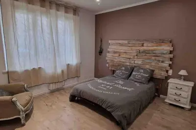 a bedroom with a bed with a wooden headboard at Les Suites du Palais in Carcassonne