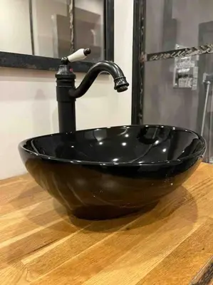 a black sink with a faucet in a bathroom at Les Suites du Palais in Carcassonne