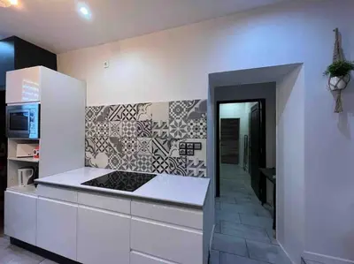 a kitchen with white cabinets and a stove top oven at Les Suites du Palais in Carcassonne