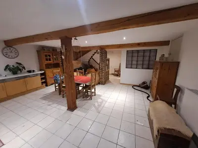 a kitchen and dining room with a table and chairs at Gîte à la ferme in La Tour-du-Crieu