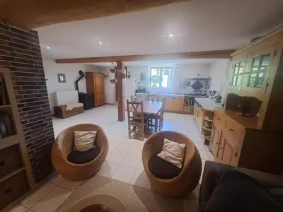 a living room with two bean chairs and a kitchen at Gîte à la ferme in La Tour-du-Crieu
