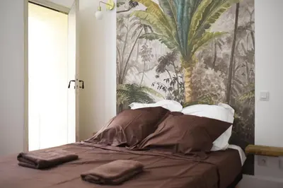 a bed with two towels on it in a bedroom at superbe appartement avec cour dans la bastide in Carcassonne