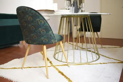 a pair of chairs sitting next to a table at superbe appartement avec cour dans la bastide in Carcassonne