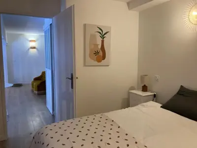 a bedroom with a bed and an open door at Maison indépendante, canal du Midi, Piscine in Homps