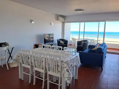 a dining room with a table and chairs and the ocean at Le Front de mer - vue imprenable in Port-la-Nouvelle