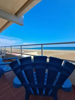 a view of the beach from a balcony at Le Front de mer - vue imprenable in Port-la-Nouvelle
