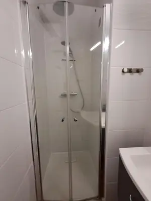 a shower with a glass door in a bathroom at Le Front de mer - vue imprenable in Port-la-Nouvelle