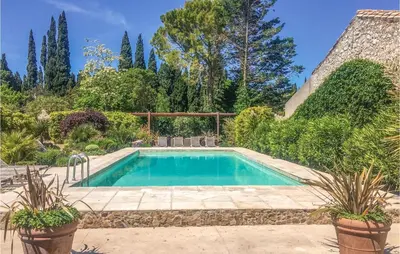a swimming pool in a garden with plants at Amazing Home In Thézan-Des-Corbières in Thézan-des-Corbières