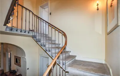 a spiral staircase in a home with a hallway at Amazing Home In Thézan-Des-Corbières in Thézan-des-Corbières