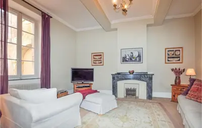 a living room with white furniture and a fireplace at Amazing Home In Thézan-Des-Corbières in Thézan-des-Corbières