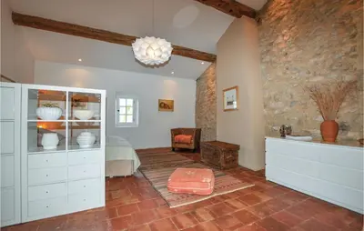 a bedroom with white cabinets and a bed in a room at Amazing Home In Thézan-Des-Corbières in Thézan-des-Corbières