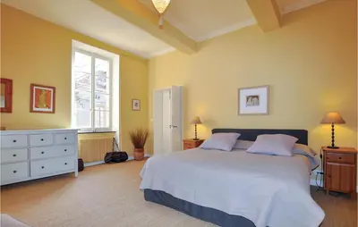 a bedroom with a large bed and a window at Amazing Home In Thézan-Des-Corbières in Thézan-des-Corbières