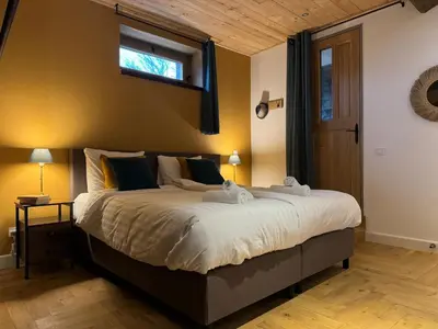a bedroom with a large bed and a window at Pax et Amor Chambres d'hôtes de charme - Charming B&B in Mazerolles-du-Razès