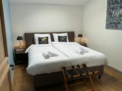 a bedroom with a bed with white sheets and a chair at Pax et Amor Chambres d'hôtes de charme - Charming B&B in Mazerolles-du-Razès