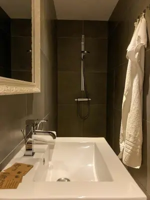 a bathroom with a white sink and a shower at Pax et Amor Chambres d'hôtes de charme - Charming B&B in Mazerolles-du-Razès