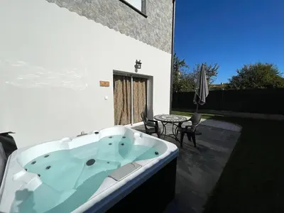 a bath tub sitting on top of a patio at Siam Mahanakhon Appart & Spa in Rieux-de-Pelleport