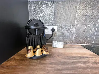 a group of shoes in a rack on a table at Siam Mahanakhon Appart & Spa in Rieux-de-Pelleport