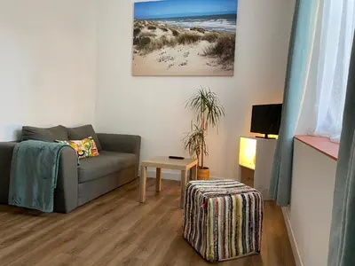 a living room with a couch and a table at Narbonne : Logement idéalement situé in Narbonne