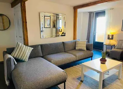 a living room with a couch and a table at Elegant and Charming Townhouse with roof terrace in Limoux