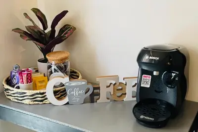 a coffee maker on a counter next to a sign at Elegant and Charming Townhouse with roof terrace in Limoux