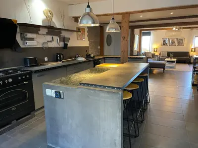 a large kitchen with a large island in the middle at Elegant and Charming Townhouse with roof terrace in Limoux