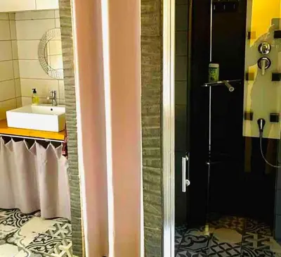 a bathroom with a shower and a sink and a shower at Elegant and Charming Townhouse with roof terrace in Limoux