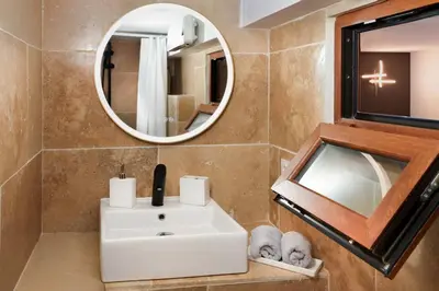 a bathroom with a white sink and a mirror at Les Remparts in Carcassonne