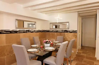 a dining room with a table and chairs at Les Remparts in Carcassonne