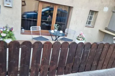 a fence in front of a house with a table at Les Remparts in Carcassonne