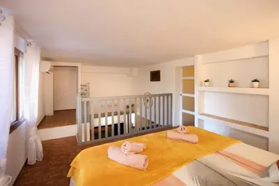 a room with a crib with pink towels on it at Les Remparts in Carcassonne