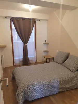 a bedroom with a bed and a window at Jolie T3 avec terrasse in Carcassonne