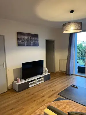 a living room with a large flat screen tv at Appartement 2 chambres narbonne in Narbonne