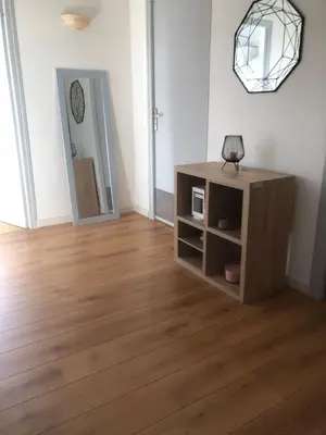 a living room with a cabinet and a mirror at Appartement 2 chambres narbonne in Narbonne