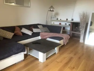 a living room with a couch and a table at Appartement 2 chambres narbonne in Narbonne