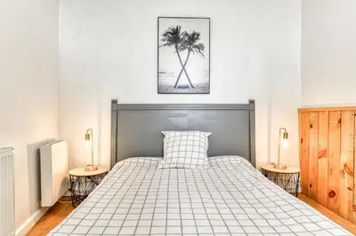 a bedroom with a large bed with two tables at Le Nid - tout à pied - Wifi in Carcassonne