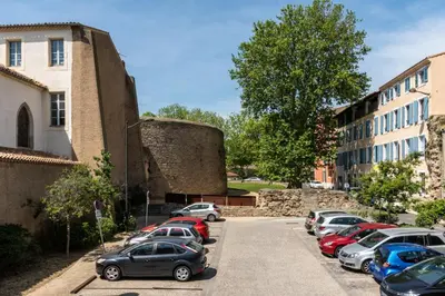a bunch of cars parked in a parking lot at Le Nid - tout à pied - Wifi in Carcassonne