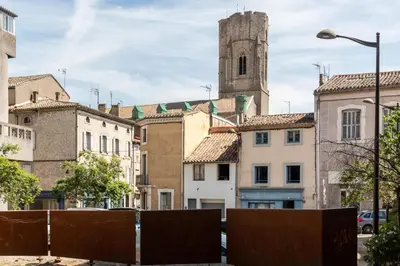 a city street with buildings and a clock tower at Le Nid - tout à pied - Wifi in Carcassonne