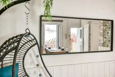a mirror on the wall of a bathroom at Le Nid - tout à pied - Wifi in Carcassonne