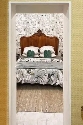 a bed with a headboard and pillows in a room at Maison Petit Arago avec roof terrace et parking privé in Carcassonne
