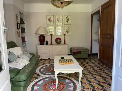 a living room with a couch and a table at Maison Petit Arago avec roof terrace et parking privé in Carcassonne