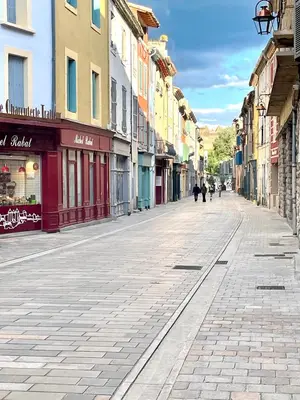 an empty street with people walking down the street at Maison Petit Arago avec roof terrace et parking privé in Carcassonne