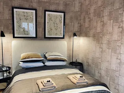 a bedroom with a bed with two towels on it at Maison Petit Arago avec roof terrace et parking privé in Carcassonne