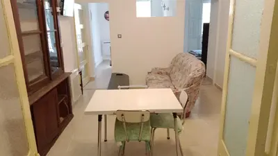 a living room with a table and a couch at L'ombrelle in Carcassonne