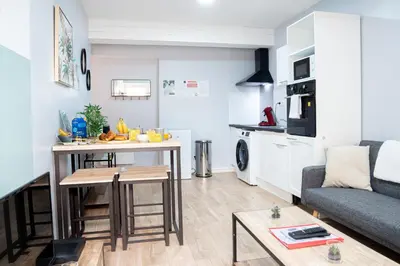 a room with a bed and a television and a patio at Au soleil levant*terrasse*Local à vélo*oc keys in Castelnaudary
