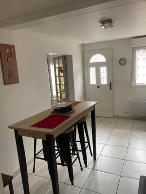 a dining room with a wooden table and chairs at Appartement à deux pas du centre ville in Limoux